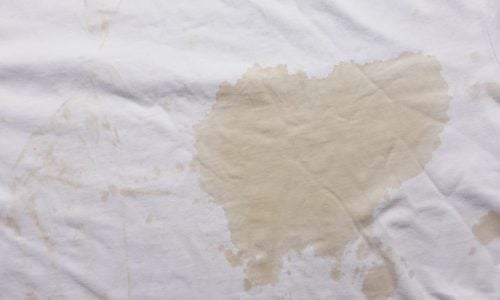 spilled coffee on white shirt closeup ,